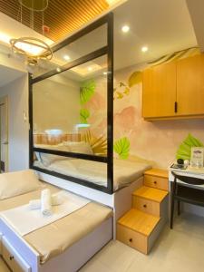 a room with two bunk beds and a table at Inspiria Condominium in Davao City +19 photos