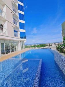 a large swimming pool in front of a building at Inspiria Condominium in Davao City