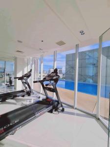 a gym with two treadmills and a large window at Inspiria Condominium in Davao City