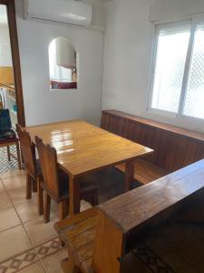 a dining room with a wooden table and chairs at El Doblao del Rey in Torrejón del Rey