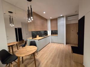 a kitchen with a table and chairs and a counter at Omega Lake Family 1 in Olsztyn