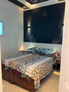 a bedroom with a bed in a room at Le central in Oran