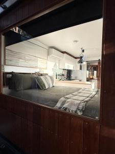 a large bed in a room with a kitchen at Sol On Loten in Mitchells Island