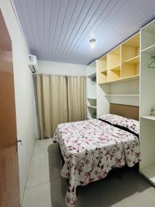 a small bedroom with a bed in a room at kitnet 1 quarto in Arroio do Silva