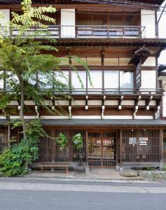 a building with a sign in front of it at ZEN Hostel in Yamanouchi