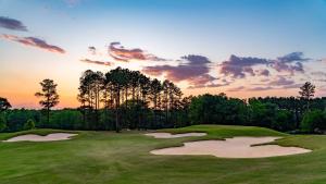 a golf course with a sunset in the background at Candlewood Suites Dothan by IHG in Dothan