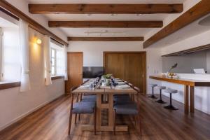 a dining room with a long table and chairs at Ito Orange Beach Villa - Ocean View & Private Onsen in Ito