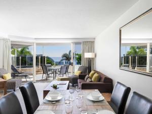 a living room with a table and chairs at Mantra Zanzibar in Mooloolaba
