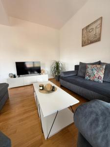 a living room with a couch and a table at KRUM Apartments in Kumanovo