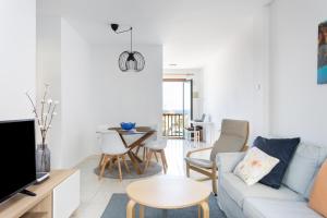 a living room with a couch and a table at Atlantic & Teide Views Penthouse in Puerto de la Cruz