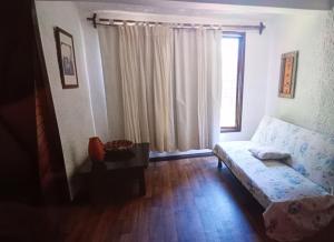 a living room with a couch and a window at Lunita in Costa Azul