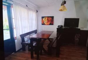 a dining room with a table and a painting on the wall at Lunita in Costa Azul +3 photos