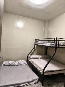 two bunk beds in a small room with a ceiling at Davao City Cozy Home in Davao City +32 photos