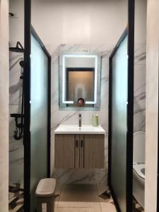 a bathroom with a sink and a mirror at Davao City Cozy Home in Davao City