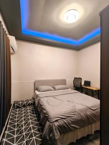 a bedroom with a bed with a blue ceiling at Davao City Cozy Home in Davao City