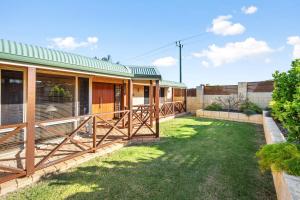 a house with a green roof and a yard at 5BR Beachside Home with Pool, Park Access in Perth
