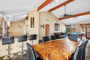a dining room with a ping pong table and chairs at 5BR Beachside Home with Pool, Park Access in Perth +41 photos