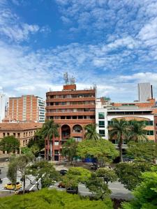 a view of a city with buildings and trees at Hotel Plaza Mayor 44 - Medellín in Medellín