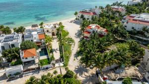 LafitteCasa Coral - 2BR - Tropical Hideout with Pool的享有海滩的空中景致,海滩上种有房屋和棕榈树