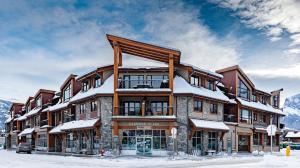 a large building with snow on top of it at El Paraiso - Luxury Downtown Penthouse in Canmore