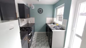 a kitchen with a sink and a stove at Rock Ferry home in Birkenhead +18 photos