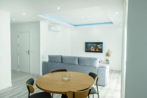 PrainhaEdifício Yes, Luxury 2 Bed Apartments, Praia, Cape Verde with Balcony and AC的客厅里有一张桌子和一张沙发