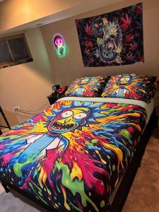 a bed with a colorful blanket on top of it at 420 Friendly 12 PM Check Out 1 Bedroom Basement in Chicago