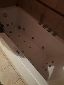 a white bath tub sitting in a bathroom at 420 Friendly 12 PM Check Out 1 Bedroom Basement in Chicago