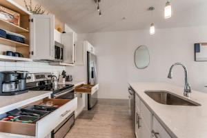 a kitchen with white cabinets and a sink at Riverwalk Oasis with Riverwalk Views Free Parking in San Antonio