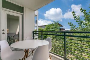 a balcony with a white table and chairs at Riverwalk Oasis with Riverwalk Views Free Parking in San Antonio