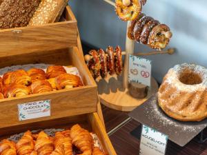 a display of different types of pastries in wooden boxes at Ibis Styles Colmar Nord in Colmar