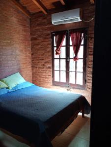 a bedroom with a bed and a window at Quinta La Nubia in Paso de la Patria +14 photos