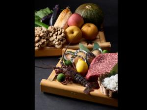 a tray of food with fruits and vegetables on it at お宿行灯鳥羽 in Toba