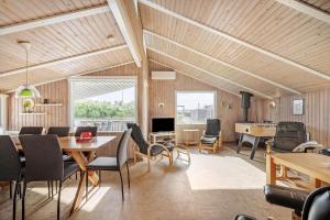 a living room with a table and chairs at 641-Hvide-Sande-Julianevej-13 in Bjerregård