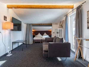 a living room with a couch and a bed at Chalet H Königsleiten in Königsleiten +32 photos
