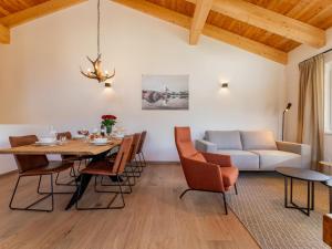 a dining room with a table and chairs and a couch at Grebenzen Lodge 51 in Sankt Lambrecht