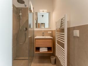 a small bathroom with a sink and a shower at Grebenzen Lodge 51 in Sankt Lambrecht +58 photos