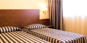 Posteľ alebo postele v izbe v ubytovaní Hotel Marconi