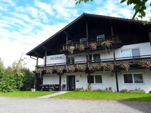 a large white building with flower boxes on it at 4 Michael Weiß Comfortable holiday residence in Reinhartsmais