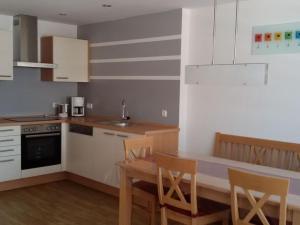 a kitchen with a table and chairs in a kitchen at 4 Michael Weiß Comfortable holiday residence in Reinhartsmais