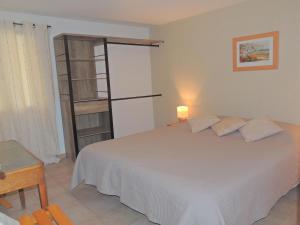 a bedroom with a white bed and a book shelf at Holiday Home in Buisson with Private Pool in Buisson +32 photos