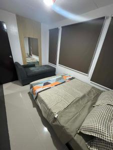 a room with a bed and a couch in it at Eko's Crib Unit 30 in Sampong +12 photos