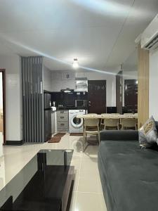 a living room with a couch and a table at Eko's Crib Unit 30 in Sampong