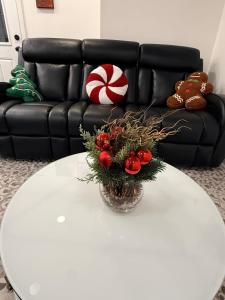 einen weißen Couchtisch mit einer Vase Blumen drauf in der Unterkunft Bluehouse in East Chicago