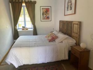 a bedroom with a white bed and a window at Hacienda Ranguil in Lolol +4 photos