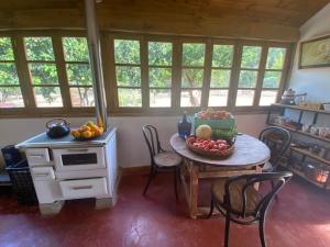 a kitchen with a table with a bowl of fruit on it at Hacienda Ranguil in Lolol