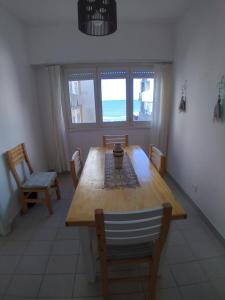 a dining room with a wooden table and chairs at VISTA AL MAR HOSPEDAJE Solo mujeres in Mar del Plata +5 photos