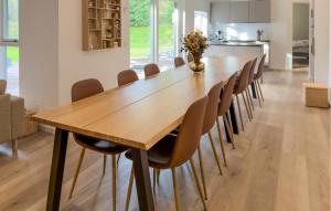 uma sala de jantar com mesa e cadeiras de madeira em Lovely Home In Ebeltoft em Femmøller