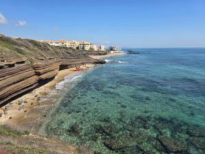 an aerial view of a beach with rocks and water at Love 2 Sans jacuzzi problème de pompe in Cap d'Agde