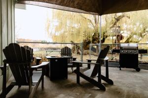 a patio with chairs and a table and a stove at Willow South Cottage in Moscow